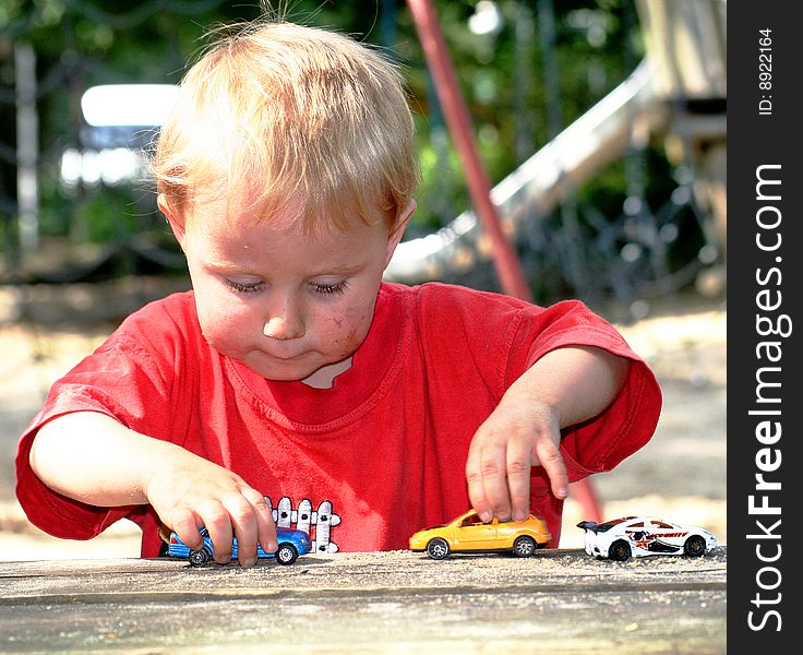 A sweet boy is playing on the playground