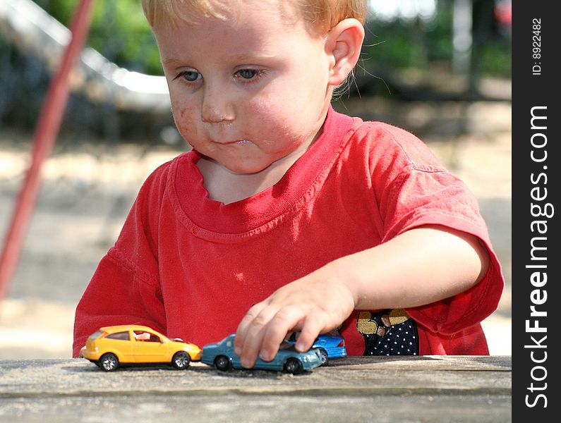 A sweet boy is playing on the playground