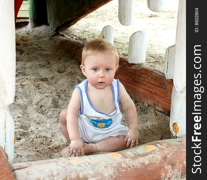 A sweet boy is playing on the playground