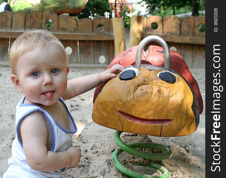 A sweet boy is playing on the playground