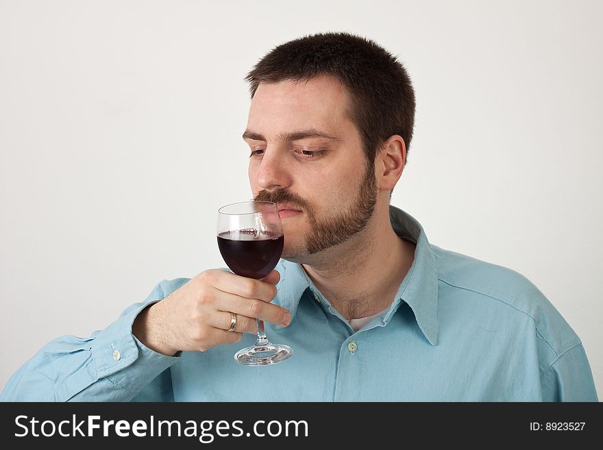Young man smelling a glass of wine. Young man smelling a glass of wine