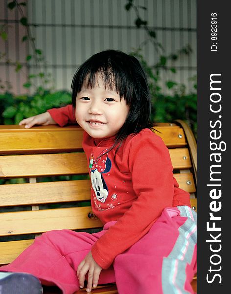 Asian Child Smile On The Stool
