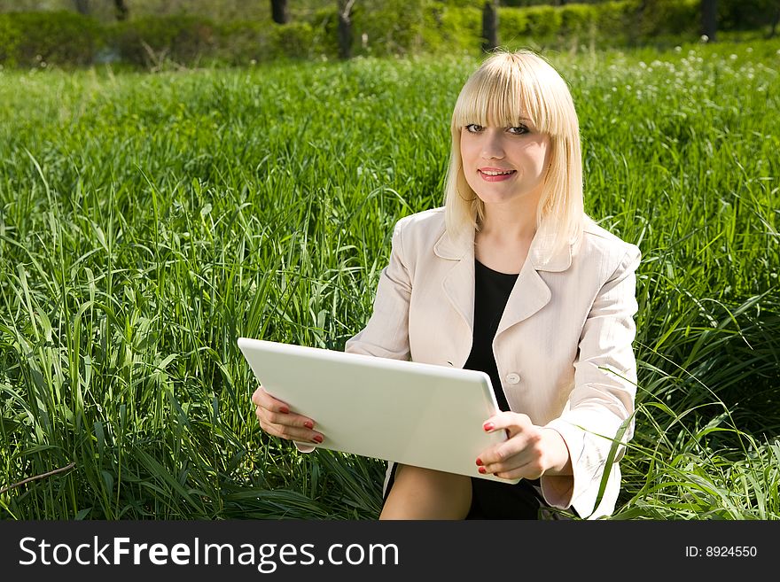 Girl with a laptop outdoors. Girl with a laptop outdoors
