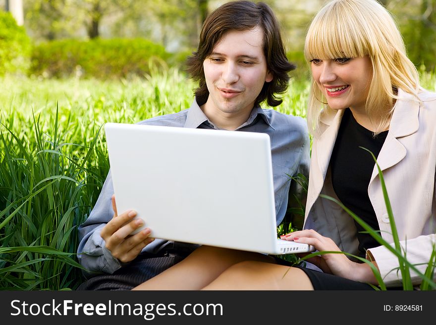 Girl and boy laugh with laptop. Girl and boy laugh with laptop