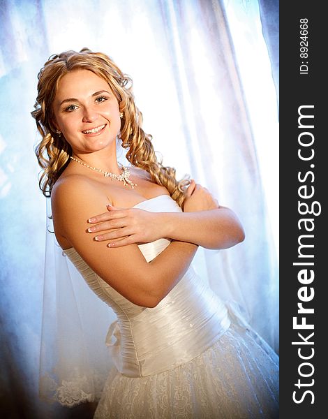 Bride near the window with curtains. Bride near the window with curtains