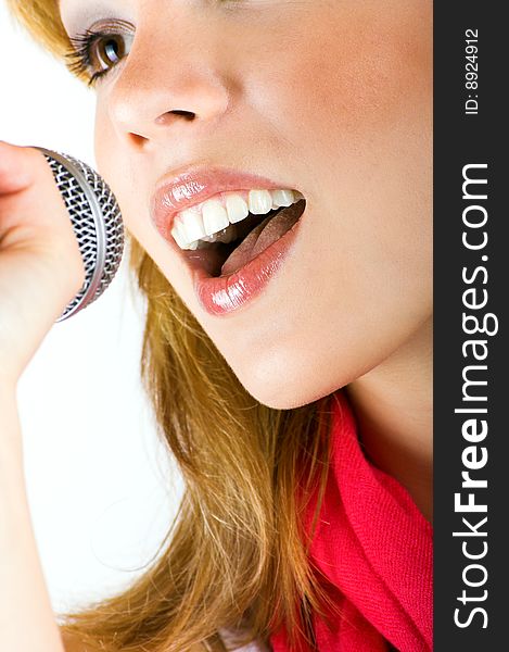 Portrait of a happy singing woman with a microphone. Portrait of a happy singing woman with a microphone