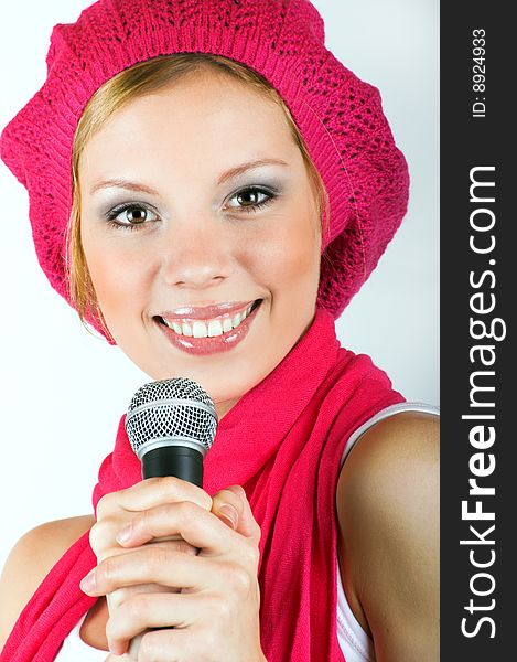 Portrait of a happy singing woman with a microphone. Portrait of a happy singing woman with a microphone
