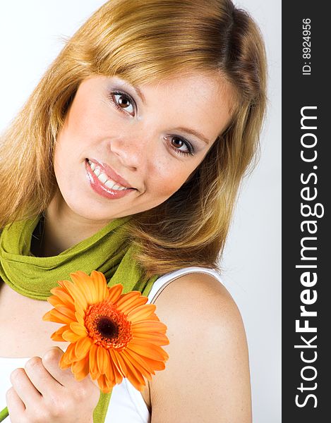 Beauty portrait of a smiling woman with a flower