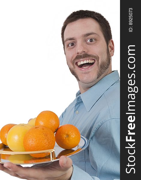 Young man serving fruit with big smile