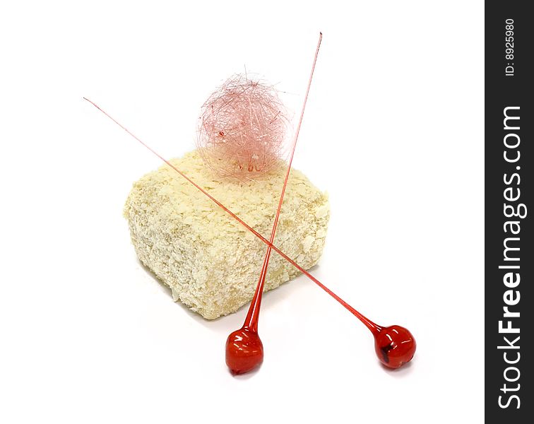 Biscuit cake with two lollipops on the white background. Biscuit cake with two lollipops on the white background