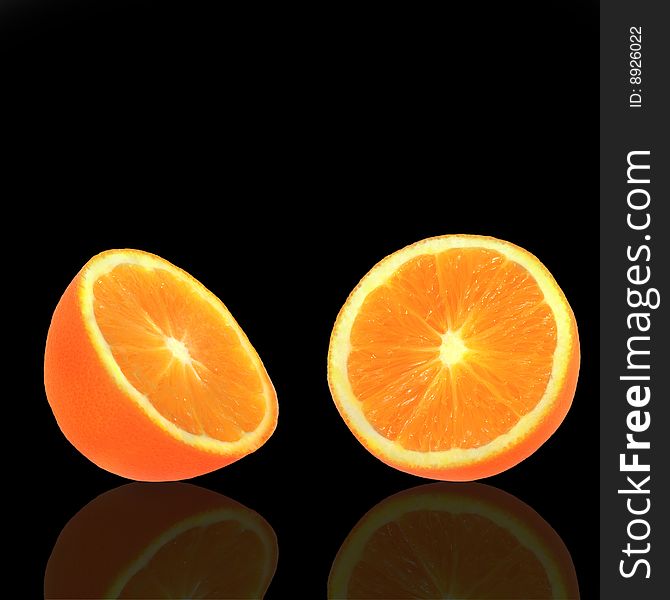 Orange fruit in two halves with reflection over black background. Orange fruit in two halves with reflection over black background.