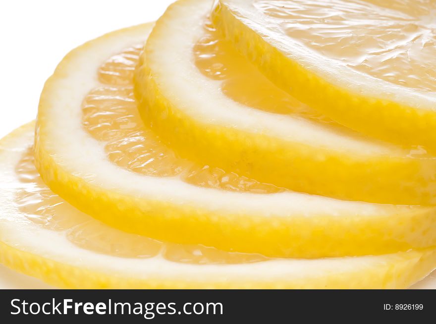 A horizontal macro of juicy fresh cut lemon slices.