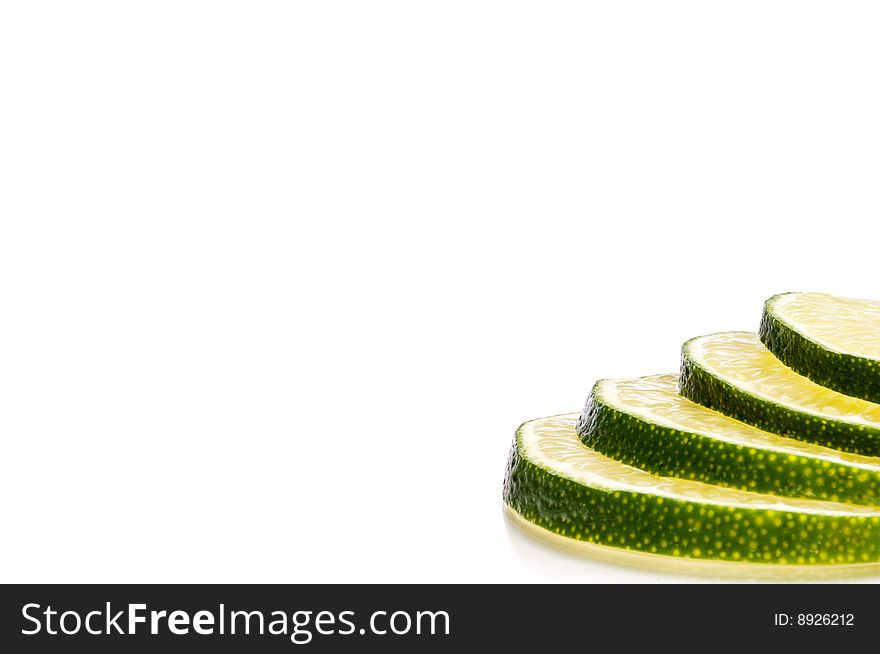 A horizontal close-up of juicy fresh cut lime slices with space. A horizontal close-up of juicy fresh cut lime slices with space