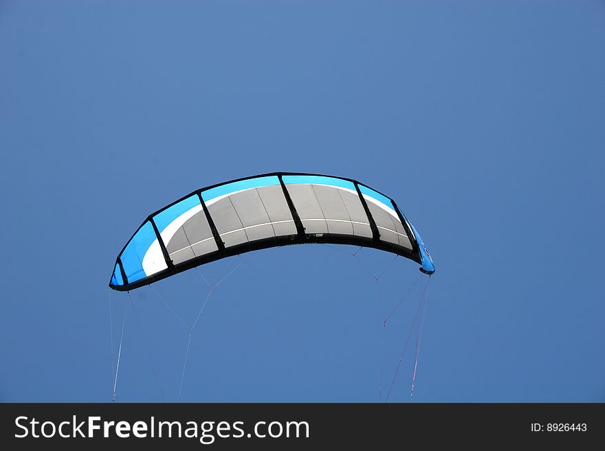 Power kite against blue sky