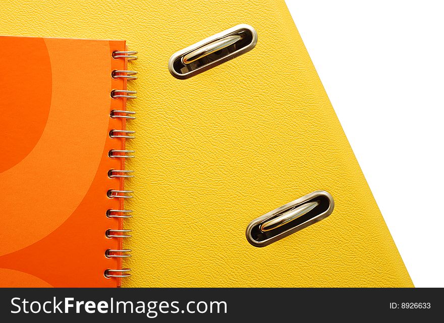 Yellow binder, orange agenda over white. Yellow binder, orange agenda over white