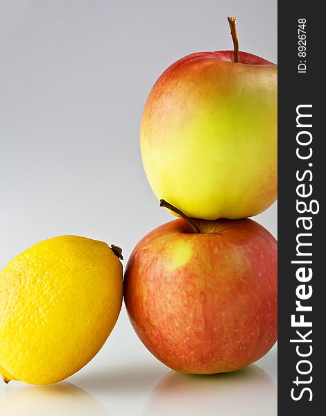 Lemon and apples on neutral background