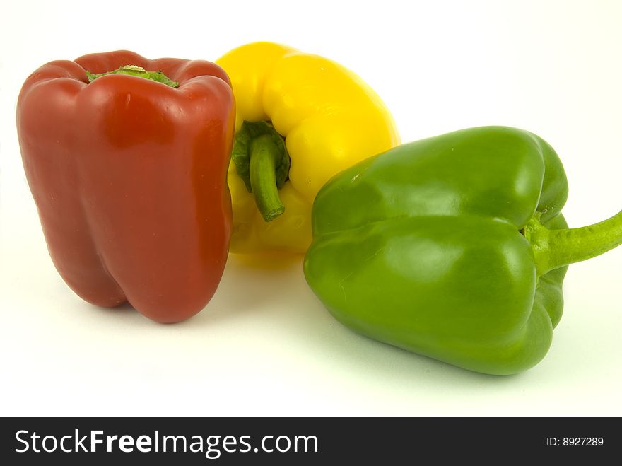 Yellow and green and red bell peppers isolated on white background. Yellow and green and red bell peppers isolated on white background