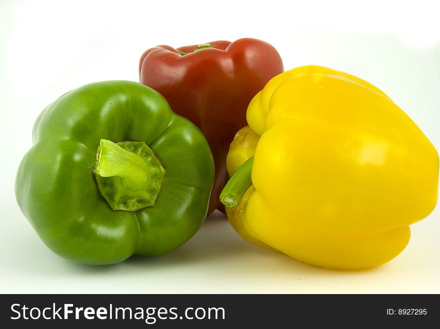 Yellow and green and red bell peppers isolated on white background. Yellow and green and red bell peppers isolated on white background