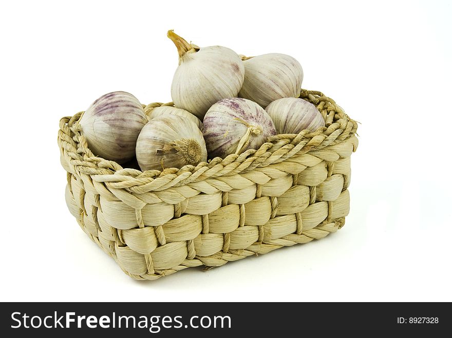 Basket full of fresh garlics isolated on white background