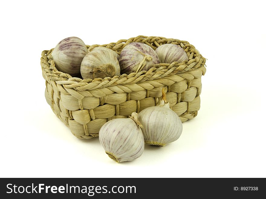 Basket full of fresh garlics isolated on white background