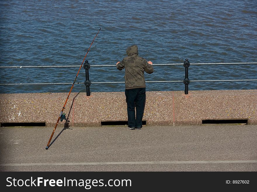 Picture of a fisherman with fishing rod