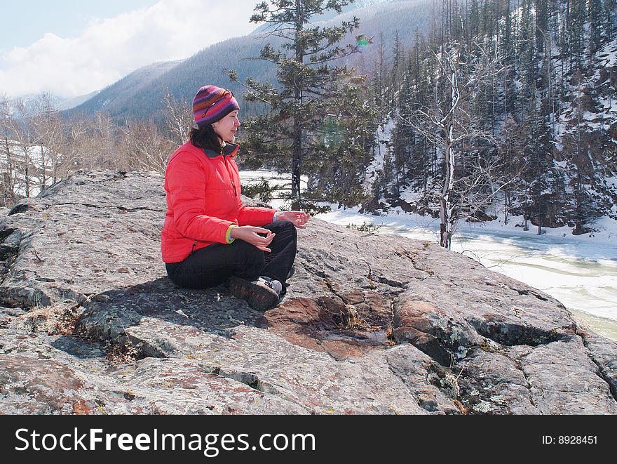 Young women meditating in spring mountains. Young women meditating in spring mountains