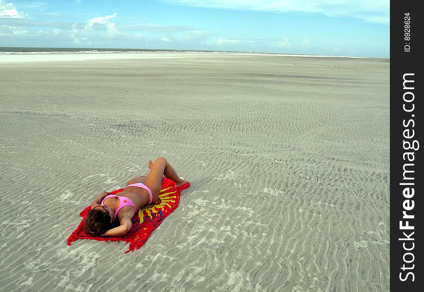 Girl in the beach lying in its towel. Girl in the beach lying in its towel