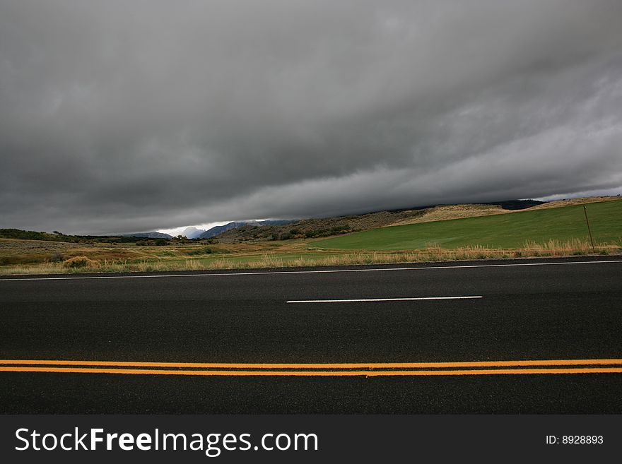 Low dark clouds hanging above hilly landscape in Colorado USA. Low dark clouds hanging above hilly landscape in Colorado USA