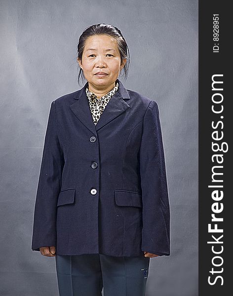 An old Chinese woman standing facing the reader. An old Chinese woman standing facing the reader.