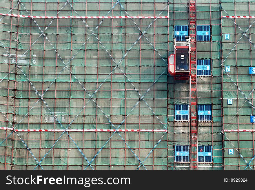 Building in construction surrounded by scaffold. Building in construction surrounded by scaffold