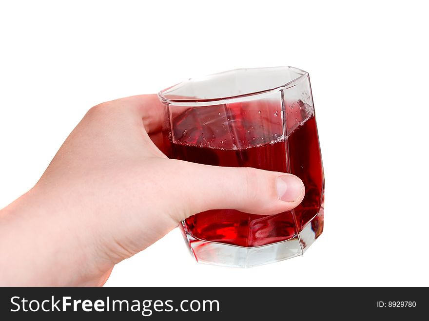 Hand holding a glass with red liquid in it. Hand holding a glass with red liquid in it