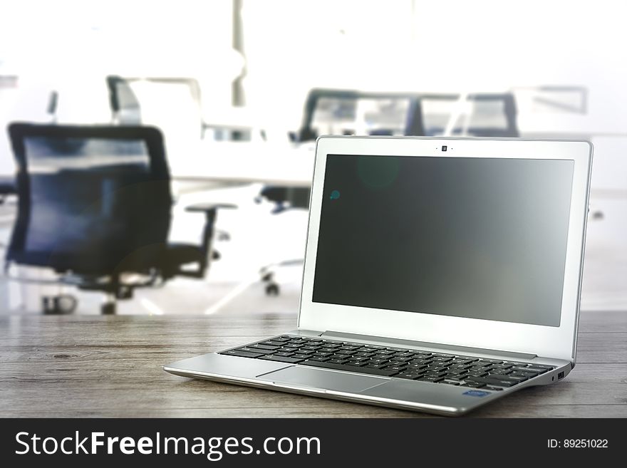 A laptop on the desk in office setting. A laptop on the desk in office setting.