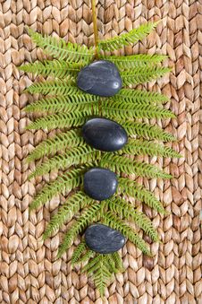 Zen Stones On A Grass Mat With A Fern Stock Photos Zen Stones On A Grass Mat With A Fern Stock Photos