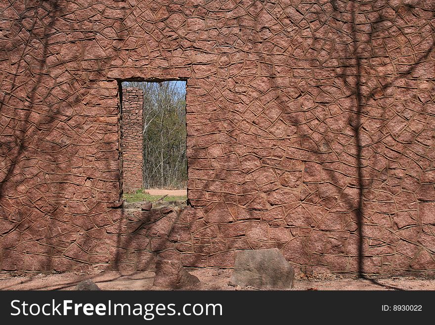 Old ruins of structure with stone construction cropped around shadow and window. Old ruins of structure with stone construction cropped around shadow and window