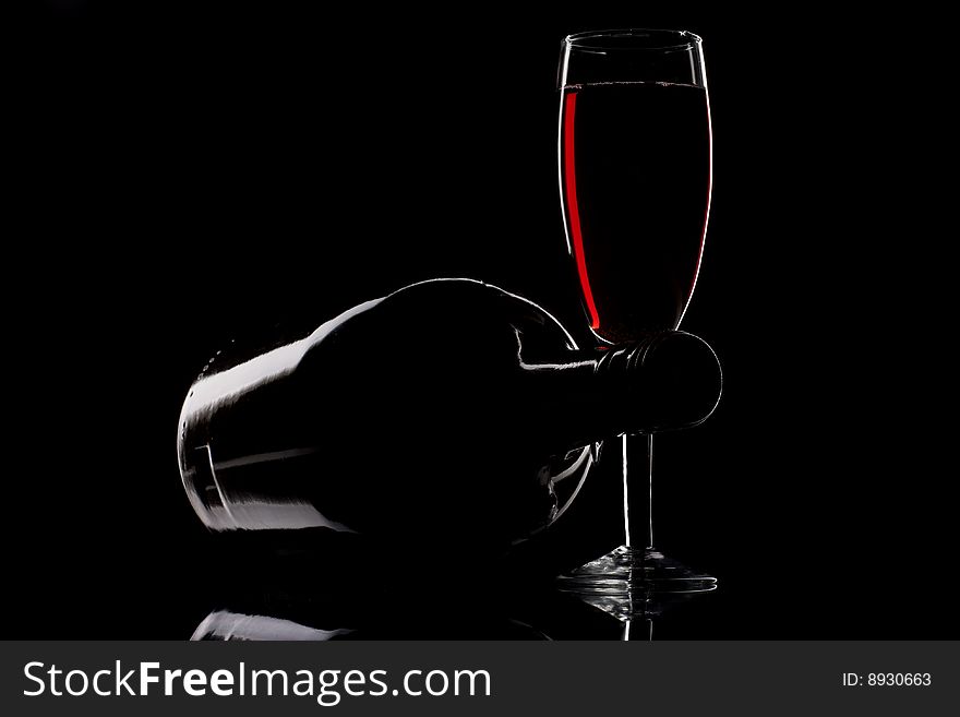 Wine glass and bottle isolated on black background. Wine glass and bottle isolated on black background