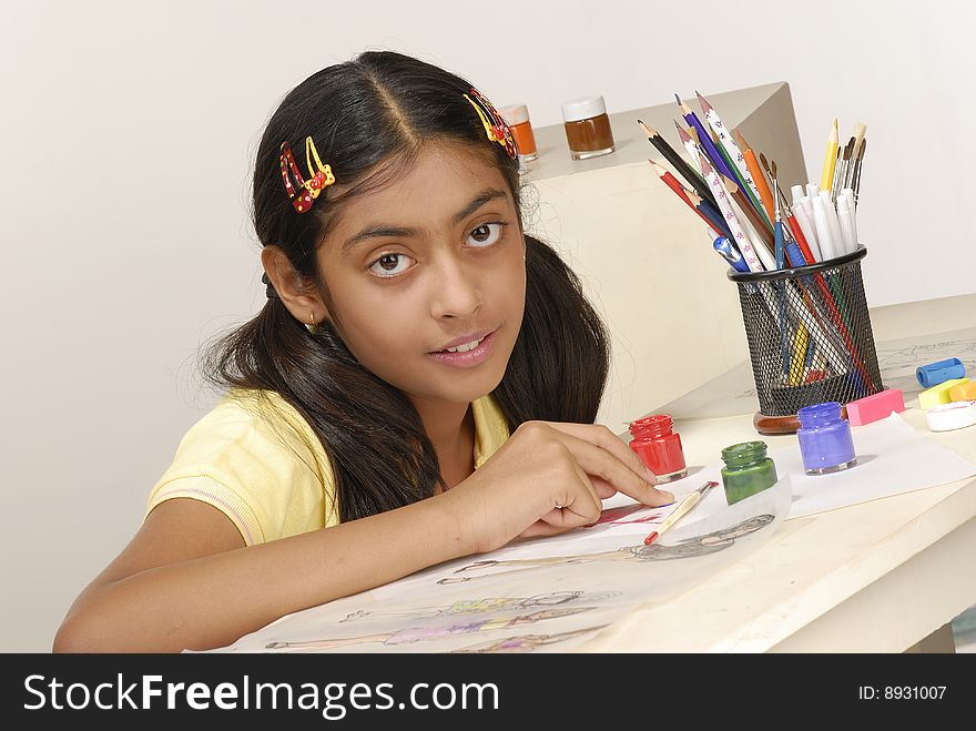 Girl draws fashion sketch with pencil colors