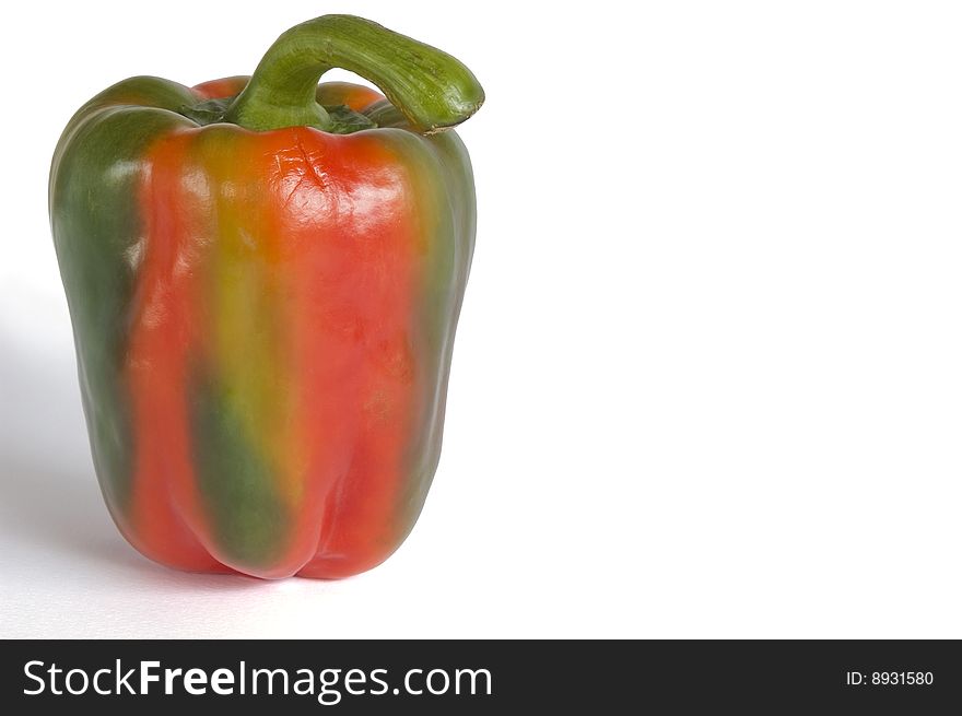 Single multi-colored - green and red pepper on white background. Horizontal image with clipping path and copy-space. Single multi-colored - green and red pepper on white background. Horizontal image with clipping path and copy-space.