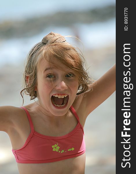 Teenage girl shouting for fun at the beach