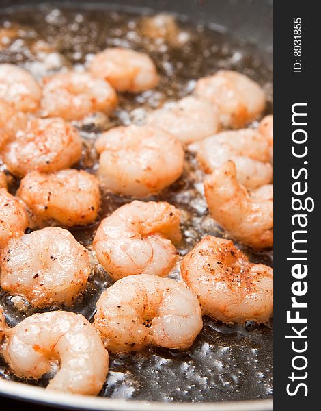 Cooking fresh peeled shrimps in a pan. Cooking fresh peeled shrimps in a pan