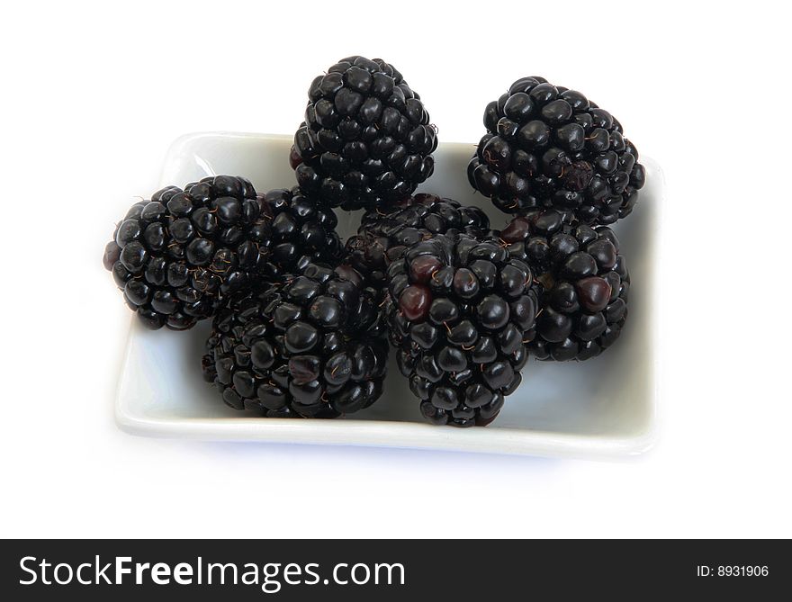 Berries of a ripe blackberry on a saucer. Berries of a ripe blackberry on a saucer