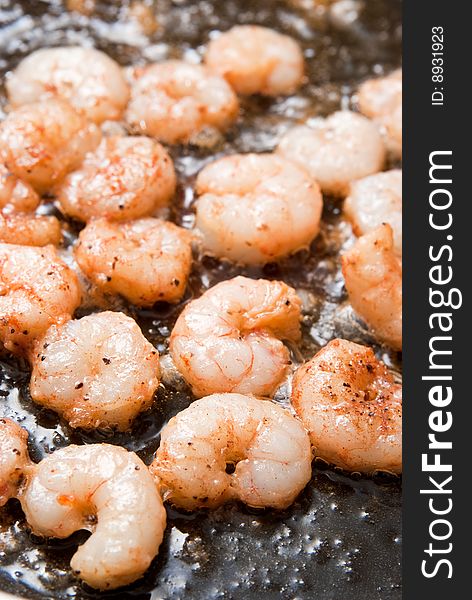 Cooking fresh peeled shrimps in a pan. Cooking fresh peeled shrimps in a pan