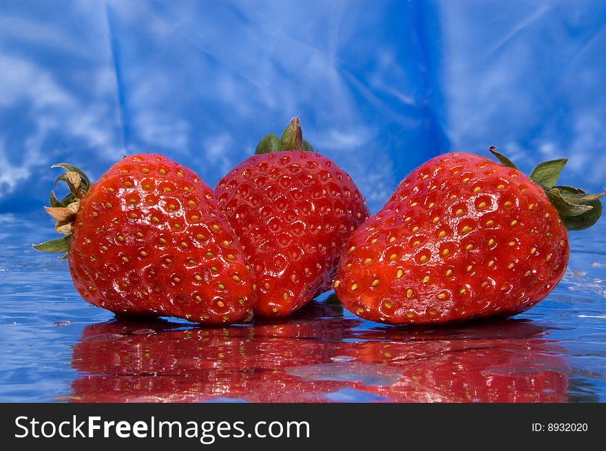 Wet Strawberries On A Blue Background