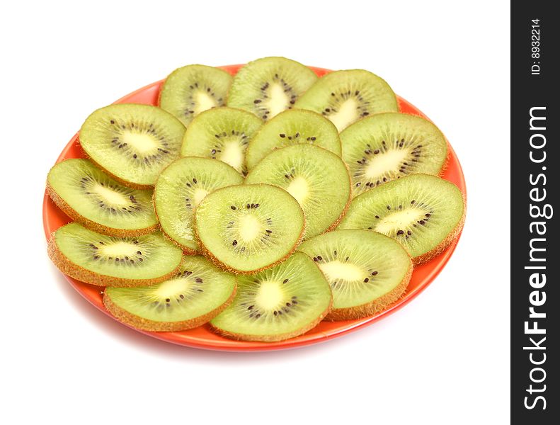 Green kiwi in plate isolated on white background