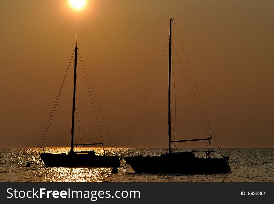 Two boat silhouettes at sunset. Two boat silhouettes at sunset