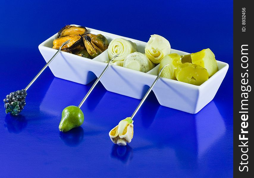 Mussels, Artichokes And Gherkins On Blue Backgroun