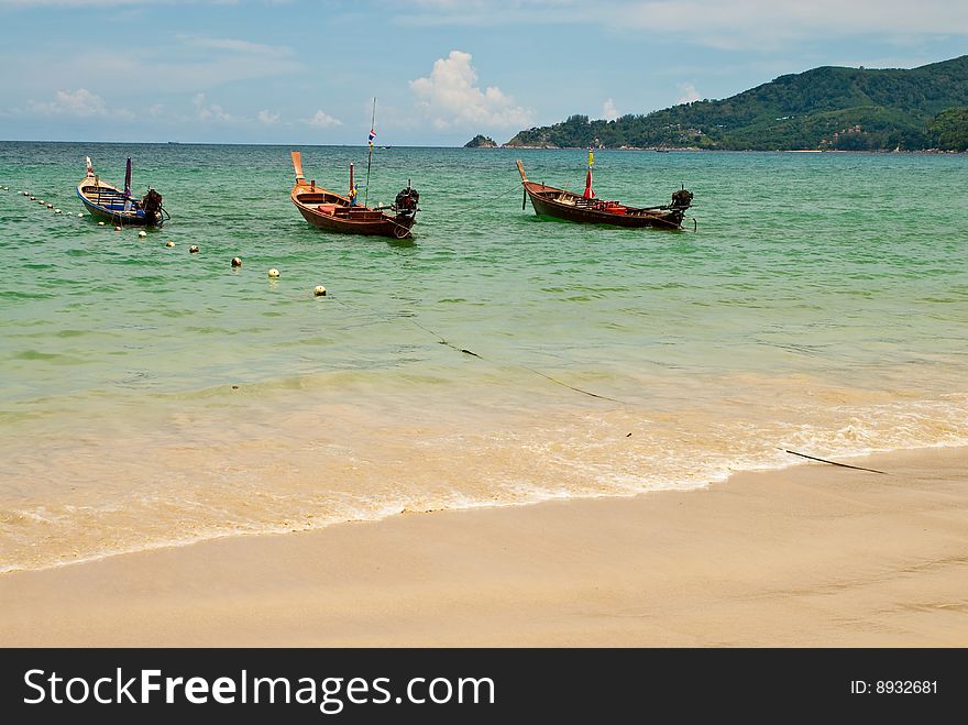 Three wooden boats at the beach