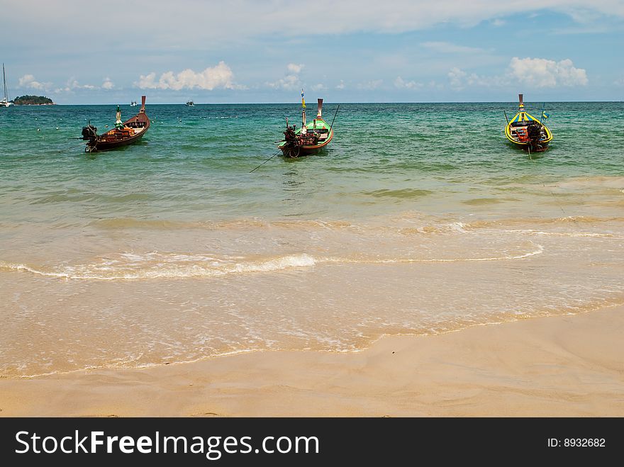Three wooden boats at the sea, Phuket, Thailand