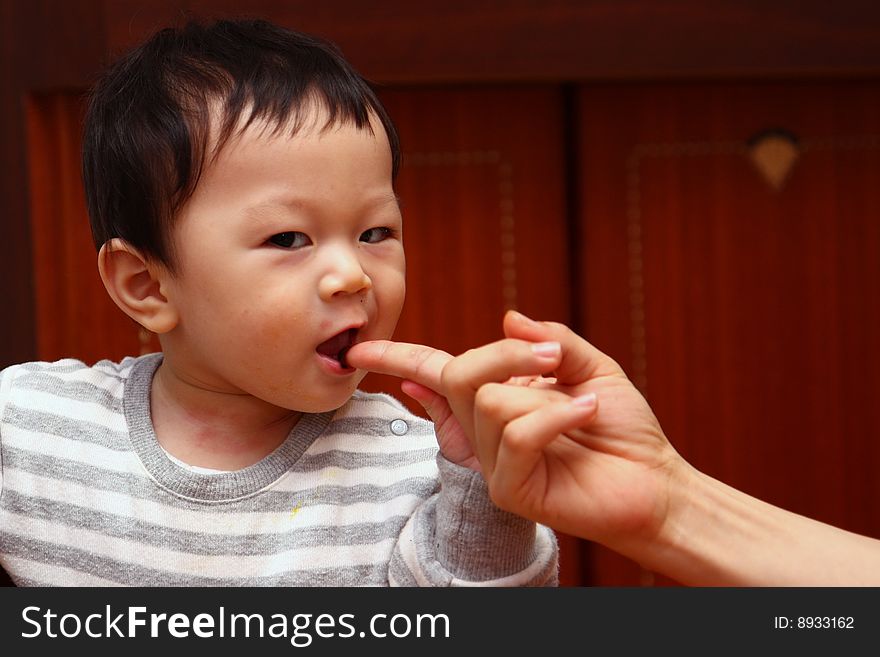 Asian child grabbing mom's hand. Asian child grabbing mom's hand