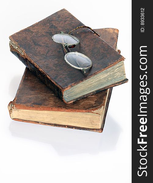 Two antiques books with spectacles isolated on white background. Two antiques books with spectacles isolated on white background