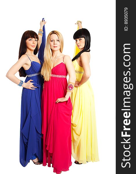 One blond and two brunette woman in red, blue, and yellow dresses. One blond and two brunette woman in red, blue, and yellow dresses